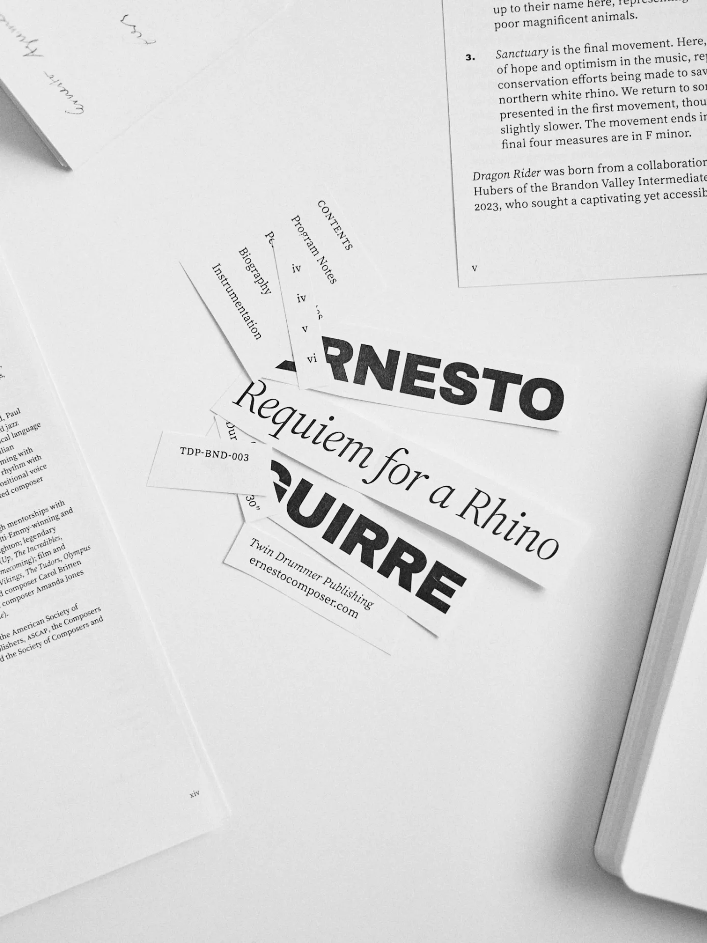 Printed score strips scattered, showing title and composer branding
